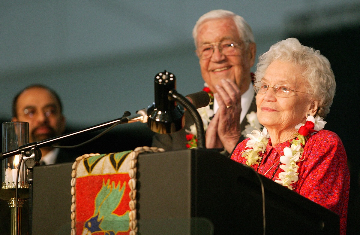 Eunice Mathews (right) is honored by the United Methodist Church's 2004 General Conference in Pittsburgh for a lifetime of service to the church. The tribute comes on her 90th birthday. Among the thousands applauding her is her husband, Bishop James, K. Mathews. A UMNS photo by Mike DuBose.