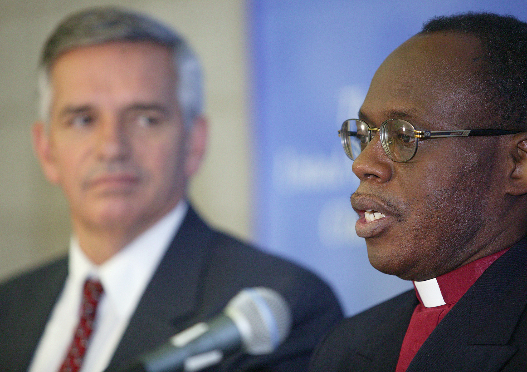 Rev. Benjamin Boni (right) and Rev. R. Randy Day announce that the million-member Protestant Methodist Church of Cote d'Ivoire is joining the United Methodist Church during a press conference at the United Methodist Church's 2004 General Conference in Pittsburgh. Boni is leader of the Cote d'Ivoire delegation to General Conference. Day is top staff executive of the United Methodist Board of Global Ministries. A UMNS photo by Mike DuBose.