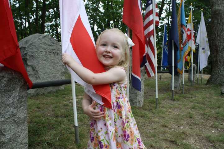 Elysia, 2, hugs a state flag during a visit to Ox Hill Battlefield Park, Fairfax County, Va. More than 1,500 soldiers were killed or wounded during this Civil War battle on Sept. 1, 1862. Photo courtesy of Seth Cooper.