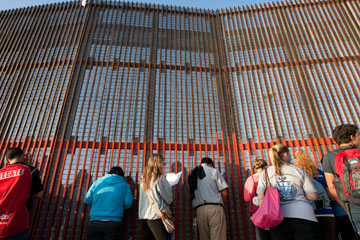 People celebrate the Posada Without Borders at El Faro Park in Tijuana, Mexico, across the border fence from San Diego. A UMNS photo by Mike DuBose.