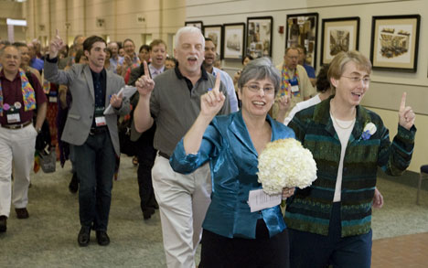 Susan Laurie (left) and Julie Bruno lead a procession through the Fort Worth Convention Center, site of the 2008 United Methodist General Conference, on the way to their marriage ceremony across the street in General Worth Square.