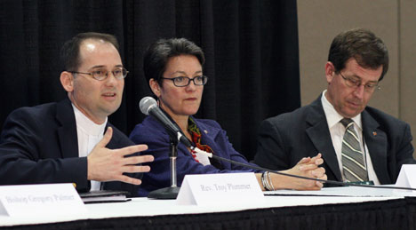 The Rev. Troy Plummer of the Reconciling Ministries Network speaks at a press conference after a time of witness on the floor of the 2008 United Methodist General Conference. Bishops Sally Dyck and Scott Jones also participate