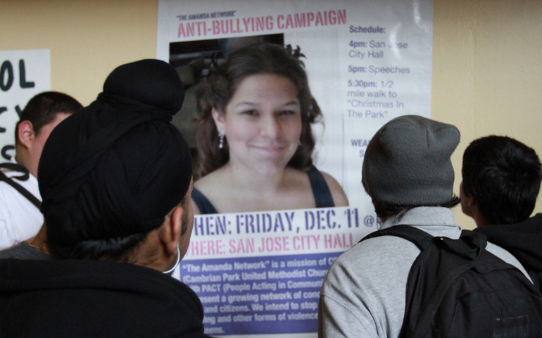 Students at Amanda’s high school view a poster featuring her portrait, which promotes an anti-bullying campaign. 