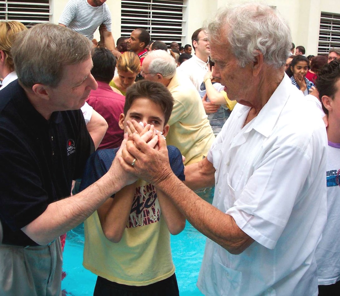 The Revs. H. Eddie Fox (right) and George Freeman join 50 other Wesleyan/Methodist clergy and bishops from throughout the Americas at a mass baptism of more than 200 adults and children in Havana in 2004. 