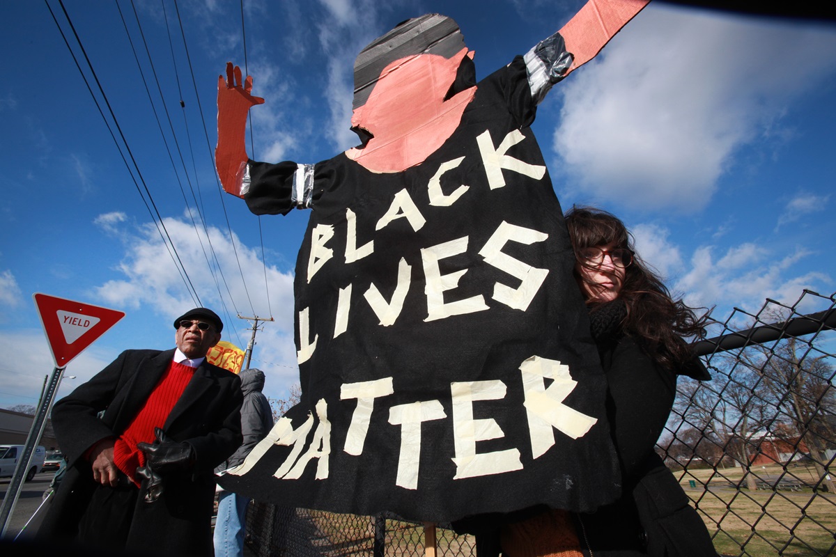 Marie Campbell, assistant director of education at United Methodist-related Scarritt-Bennett Center, holds a sign reading, "Black Lives Matter." Demonstrators gather on Dec. 9  in Nashville, Tenn., to show their support for immigration reform as well as support for racial justice. The man to the left is  the Rev. Edward Thompson, an African Methodist Episcopal Church minister.  Photo by Kathleen Barry, UMNS