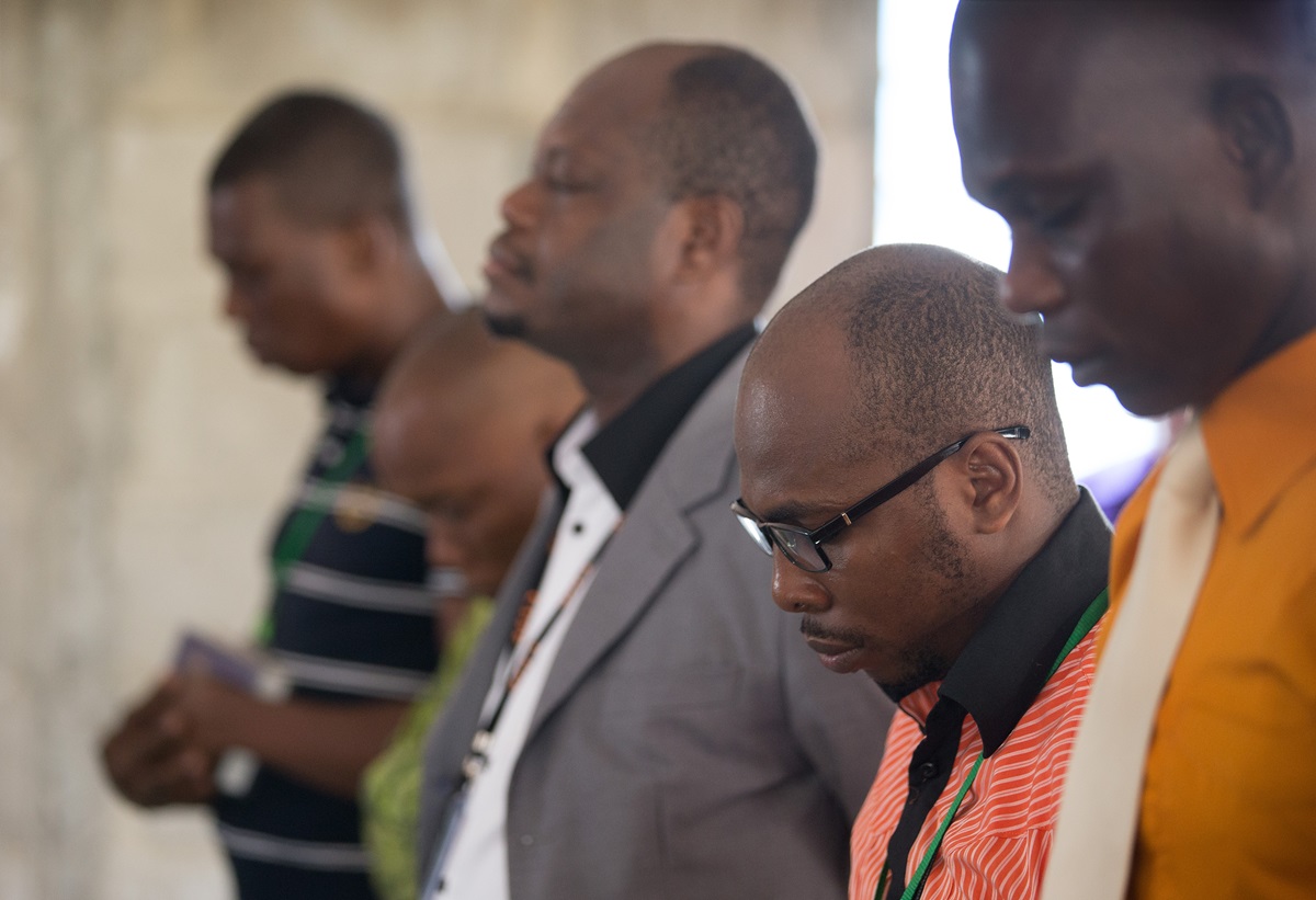 Employees of The United Methodist Church's Voice of Hope radio station in Abidjan, Côte d'Ivoire, pray during a devotional service for station staff. Photo by Mike DuBose, UMNS