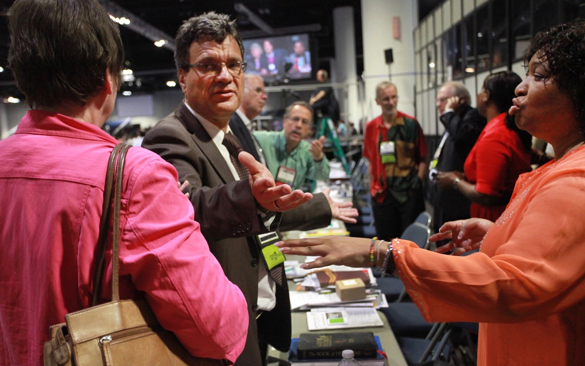 Leaders of the United Methodist Church confer during a special recess following the Judicial Council's unanimous decision that the restructuring plan is unconstitutional.  (From left) Karen Greenwald, Thomas Kemper, Larry Hollon, Gil Hanke, Bob Williams, Erin Hawkins and M. Garlinda Burton.  