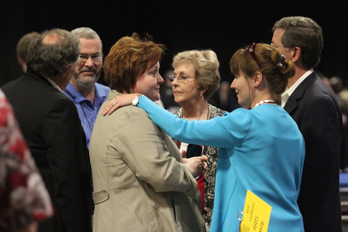 Delegates  from the West Memphis and Tennessee Conferences (from left) David Reed, Sky McCracken, Selena Henson Sandra Burnett, Harriott Bryan and Randy Cooper, confer with each other following the decision of “Plan UMC” to be declared unconstitutional during the May 4 plenary of the 2012 United Methodist General Conference in Tampa, Fla.