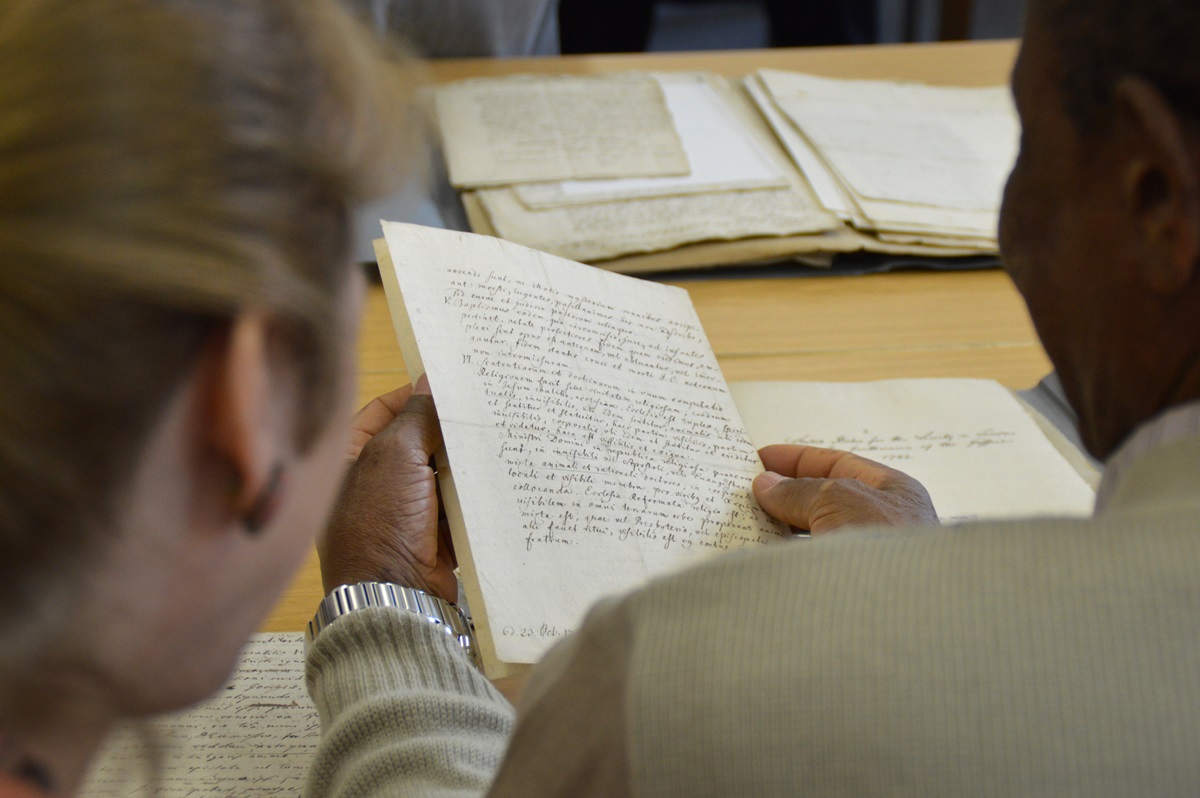 The Rev. Jean Hawxhurst and Zimbabwe Area Bishop Eben K. Nhiwatiwa examine letters exchanged by John Wesley and Count Nikolaus Ludwig von Zinzendorf. During a pilgrimage to Herrnhut, Germany, United Methodists visited the Moravian Church’s archives. Photo by Klaus Ulrich Ruof