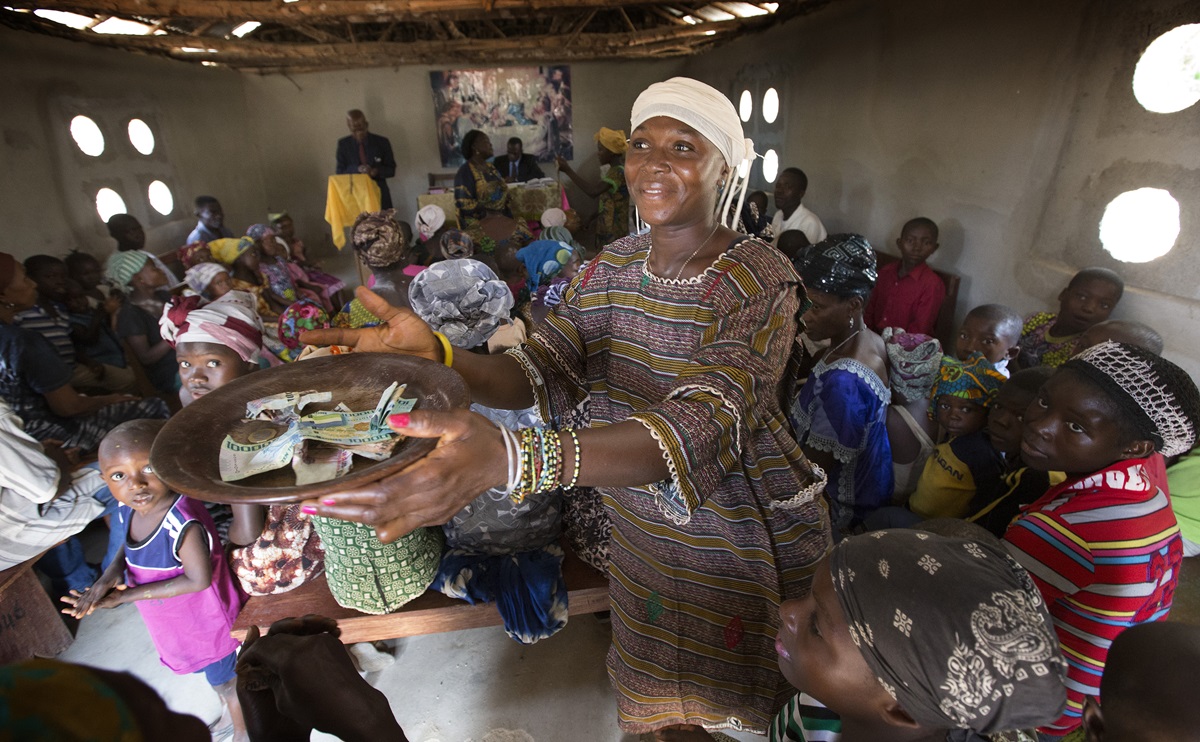 Zainab Koroma collects the offering at the United Methodist church in Fulawahun, near Bo, Sierra Leone. 