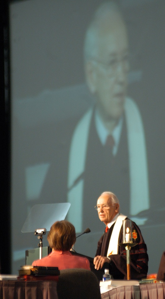 United Methodist Bishop Robert E. Fannin (at podium and reflected in video screen), Birmingham Area, gives the sermon during morning worship on May 6 at the denomination's 2004 General Conference in Pittsburgh. At left is presiding Bishop Janice Riggle Huie. A UMNS photo by John C. Goodwin.