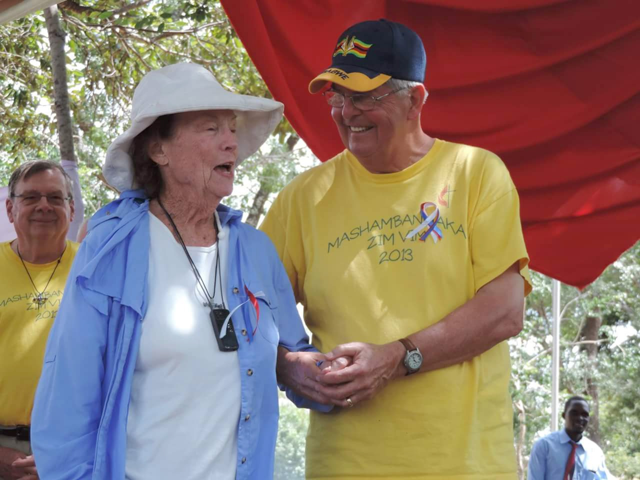 Claire Burrill, 90, and Charlie Moore help celebrate the dedication of new classrooms. Photo by Eveline Chikwanah