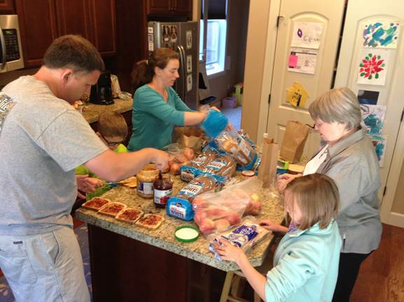 Leaders of SpiritSpace and their families prepare sandwiches to hand out to homeless individuals. SpiritSpace is among the new church starts in Portland, Ore.,  bringing people into Christian community.  Photo courtesy of the Rev. Beth Ann Estock