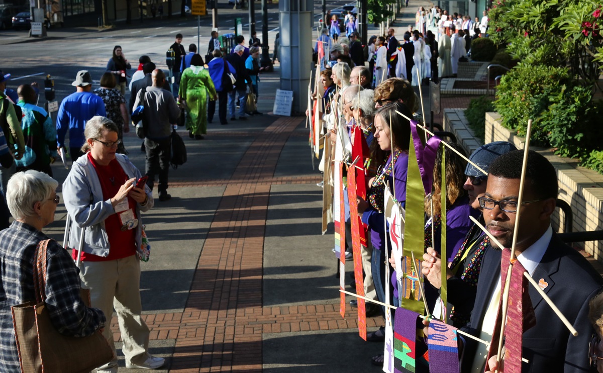 Theon Johnson III (at right) and others in support of LGBTQ clergy line the entryway to the 2016 United Methodist General Conference May 18 in Portland, Ore.  The demonstration was carried out in silence as attendees walked past to enter the Oregon Convention Center. Photo by Kathleen Barry, UMNS