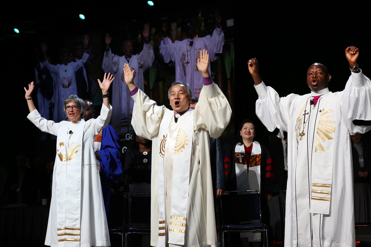 (From left) Bishops Hope Morgan Ward, Hee-Soo Jung, and John Yambasu shout, "Go" following the end of the commissioning of missionaries at the May 19 United Methodist General Conference in Portland, Ore. Photo by Kathleen Barry, UMNS