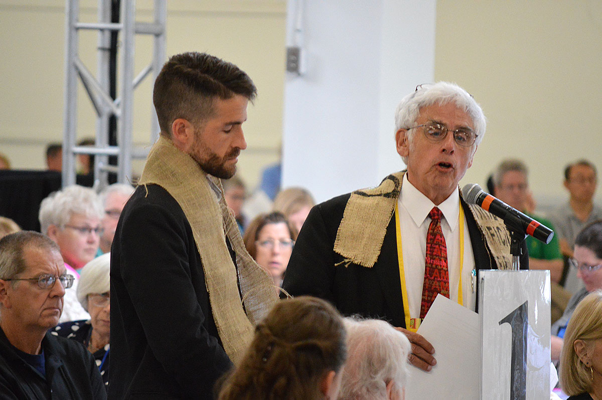 The Revs. Will Green (left) and John Blackadar offer a resolution that the New England Conference of The United Methodist Church "will not conform or comply with provisions of the Discipline which discriminate against LGBTQIA persons," during the June 2016 conference meeting in Manchester, N.H. Photo by Beth DiCocco, New England Conference.
