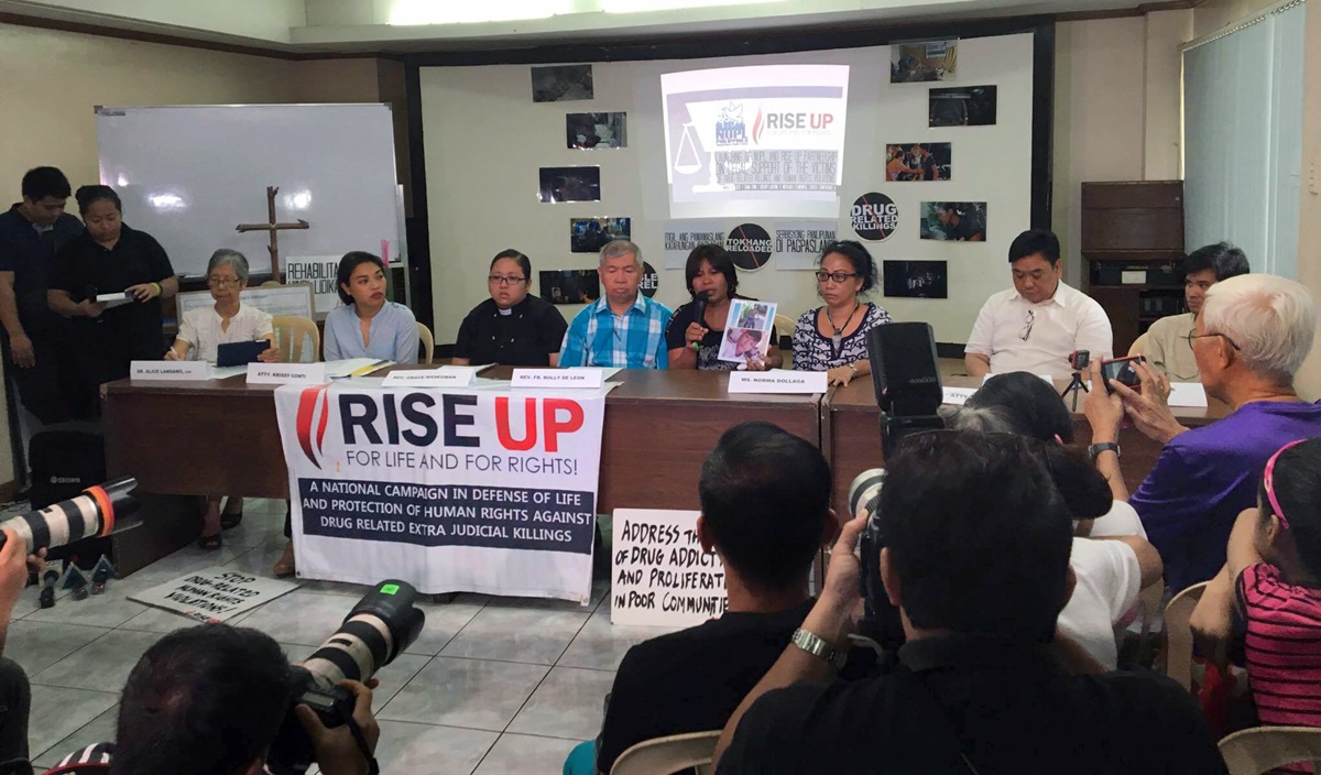Rise Up for Life and for Rights and the National Union of People’s Lawyers-National Capital Region joined forces during a press conference to condemn drug-related extrajudicial killings and violations. Emily Soriano holds a photo of her son, who was killed in 2016. To her left are Norma P. Dollaga, a United Methodist deacon, and Ephraim Cortez, an attorney who is a United Methodist. Photo courtesy of Rise Up for Rights and For Life.