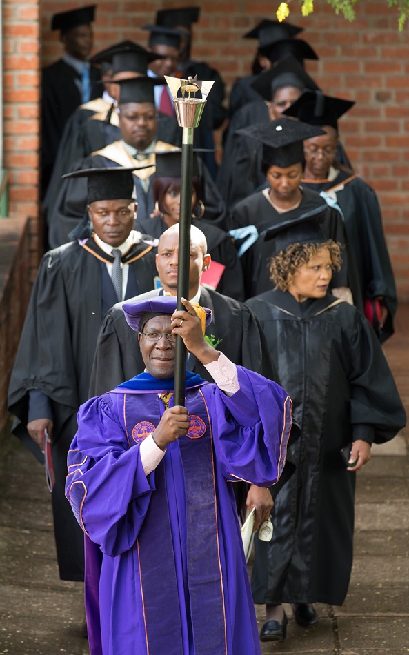 Mace bearer Walter Manyangarirwa leads the academic procession to open the 25th anniversary celebration for Africa University in Mutare, Zimbabwe. Manyangarirwa was a member of the first graduating class of the United Methodist institution. Photo by Mike DuBose, UMNS.