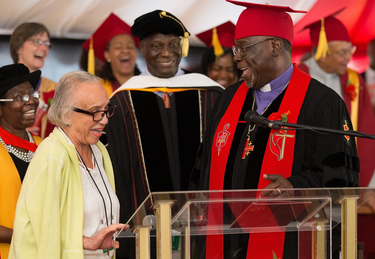 United Methodist Bishop James Swanson (right) and James Salley (center) accept a $1,000 gift for Africa University from Mabel Middleton (left, foreground) during the 25th anniversary celebration for the United Methodist school in Mutare, Zimbabwe. Photo by Mike DuBose, UMNS.
