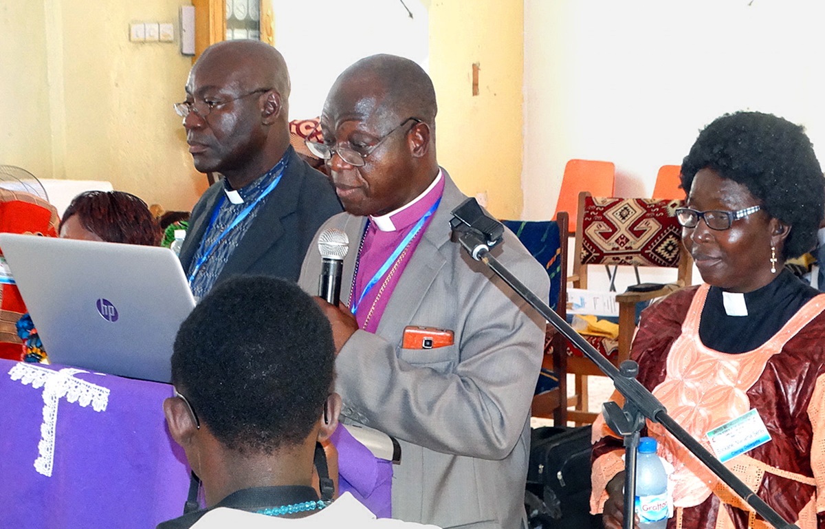 United Methodist Bishop John K. Yambasu, surrounded by his cabinet, reads from his episcopal speech March 8-12 in Makeni, Sierra Leone. In his speech, Yambasu delivered a “wake-up call” to the Sierra Leone Annual Conference about the possibility of a global church split in 2020. Photo by Phileas Jusu, UMNS.