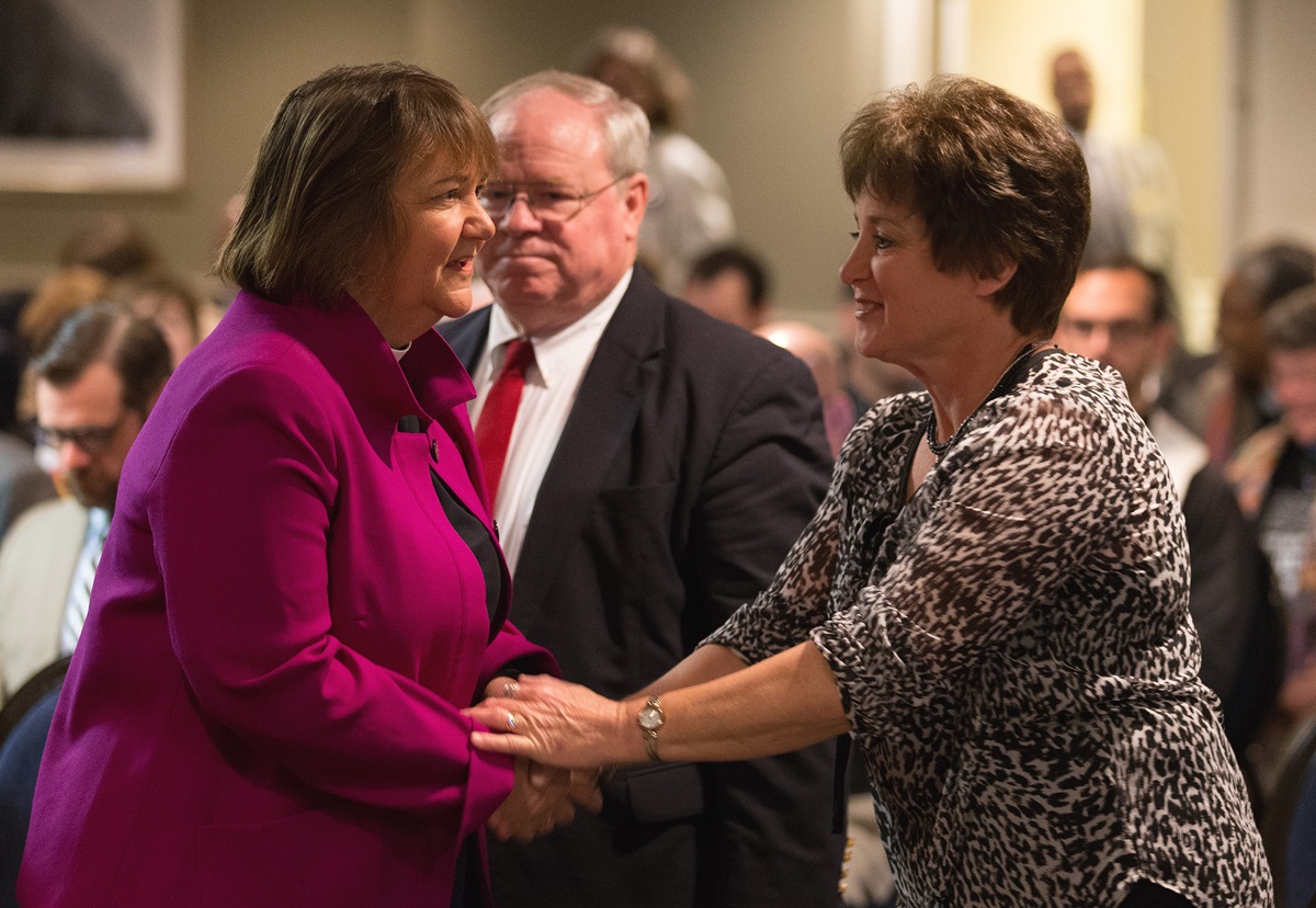 Bishop Karen Oliveto (left) meets Dixie Brewster (right) for the first time prior to the opening of oral arguments before the United Methodist Judicial Council meeting in Newark, N.J. Brewster is petitioner questioning whether a gay pastor can serve as a bishop in The United Methodist Church. At rear is the Rev. Keith Boyette, representing Brewster before the council. Photo by Mike DuBose, UMNS.