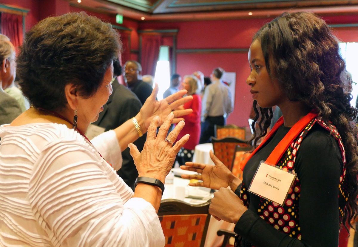 Connectional Table members Josephine Deere of Oklahoma, left, and Miracle Oscan of Malawi discuss the connections among different parts of The United Methodist Church during an icebreaking exercise. The Connectional Table, meeting in Oslo, Norway, approved a plan that ties agency evaluation to the denomination’s budget. Photo by Heather Hahn, UMNS.