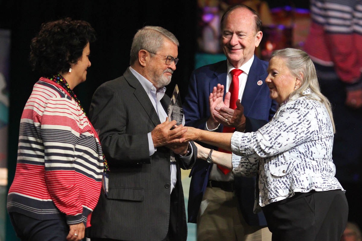The Rev. Oscar Bolioli and Maria Cristina Ferrou accept the Council of Bishops Ecumenical Award from Bishop Mary Ann Swenson on behalf of the Rev. Mortimer Arias of Uraguay while the Rev. Don Messer applauds. The award was presented during the May 17 morning worship of the United Methodist 2016 General Conference in Portland, Ore. File photo by Maile Bradfield, UMNS.