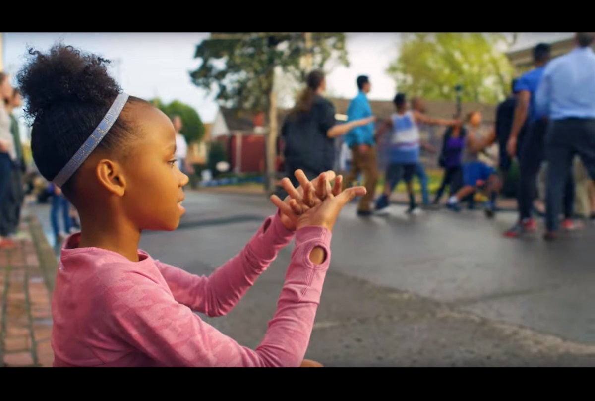 In Discipleship Ministries' video introducing the "See All the People" initiative, a girl plays the nursery rhyme game of that name, as the pastor and several staff members of a church join in a basketball game with neighborhood children. Video image courtesy of Discipleship Ministries.