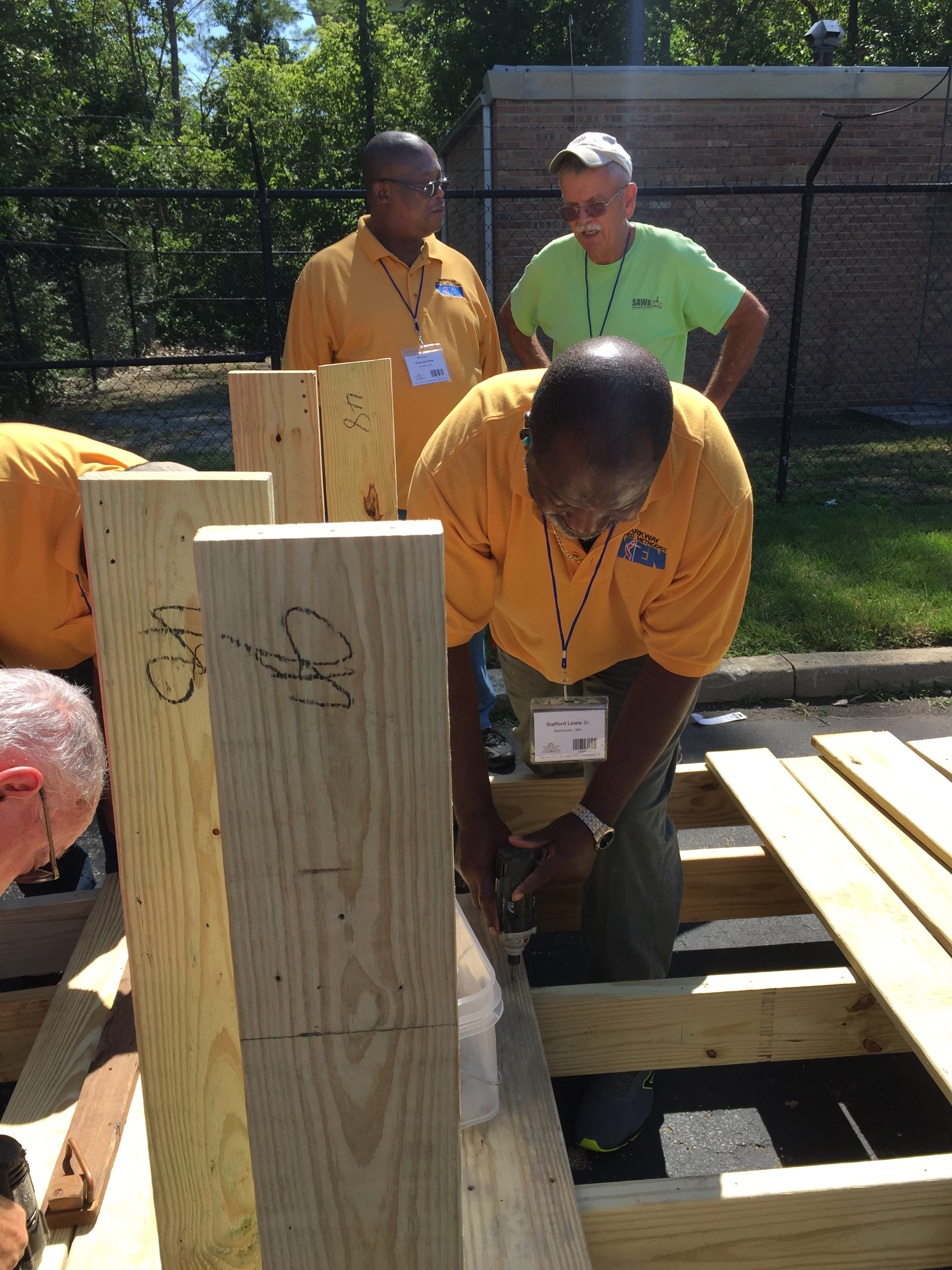 Members of United Methodist Men join with Servants at Work (SAWs), a ministry of St. Luke's United Methodist Church in Indianapolis, to construct wheelchair ramps. Many of the men involved in the project were from Parkway United Methodist Church in Milton, Mass. Photo by Heather Hahn, UMNS.