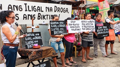 In a file photo from December 2016, Norma Dollaga, on left with microphone, speaks during an ecumenical action of Kadamay: Stop the Killings, a community organization that advocates for the poor in urban communities, in Quezon City, Philippines. The placards in Filipino say, "Dismantle illegal drugs, Save the victims!" Photo courtesy of Norma Dollaga. In a file photo from December 2016, Norma Dollaga, on left with microphone, speaks during an ecumenical action of Kadamay: Stop the Killings, a community organization that advocates for the poor in urban communities, in Quezon City, Philippines. The placards in Filipino say, "Dismantle illegal drugs, Save the victims!" Photo courtesy of Norma Dollaga.
