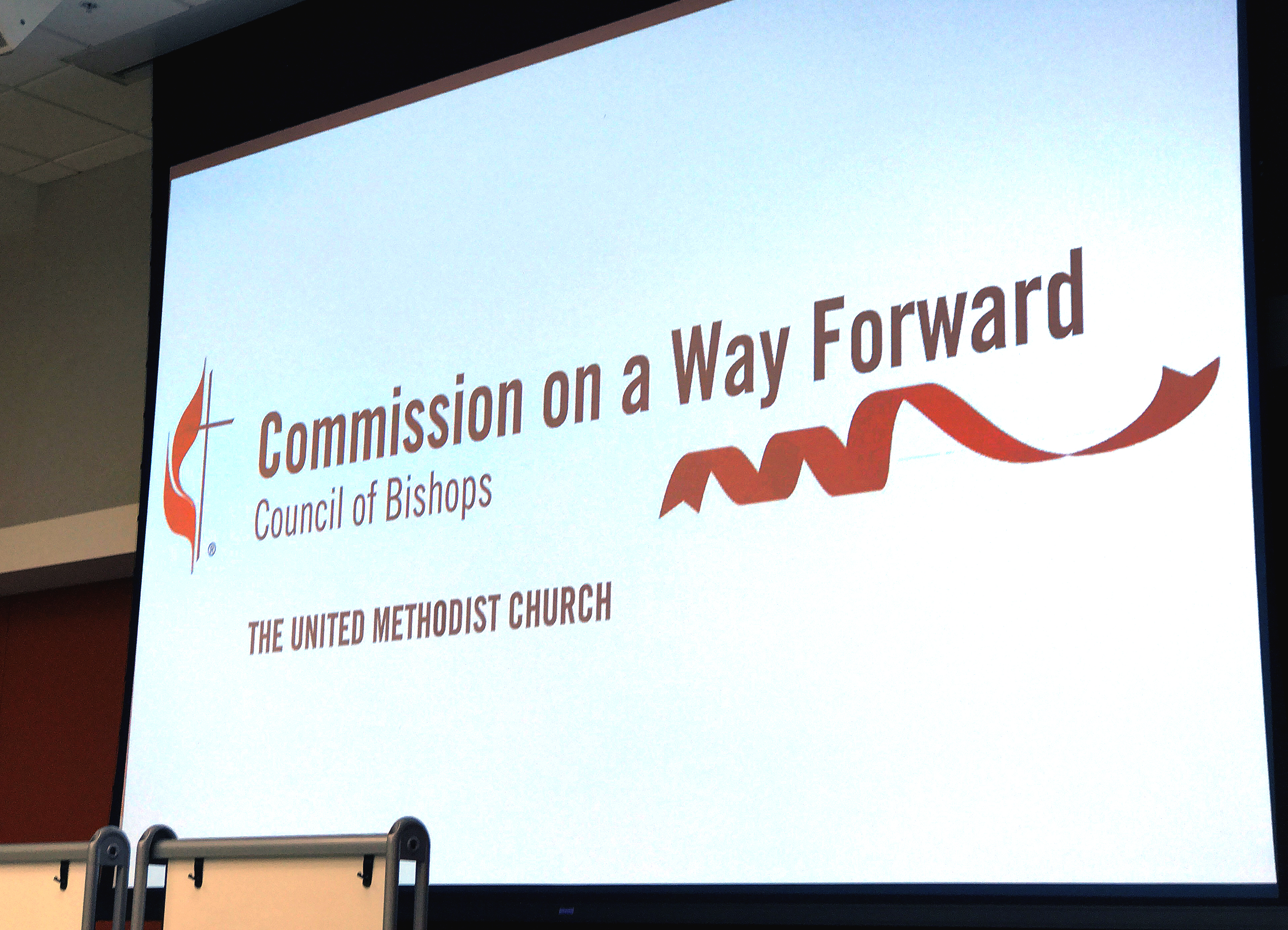 The logo for the Commission on a Way Forward is projected onto a screen during the group’s first face-to-face meeting in January 2017. Photo by Diane Degnan, United Methodist Communications.