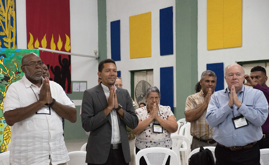 (From left) Bishop Jonathan Holston, the Rev. Carlos Cornejo, Claudete Mora, the Rev. Luis Soto and Bishop Mike McKee use body movement to pray the Lord’s Prayer as part of a devotion given by Bishop Cynthia Moore-Koikoi, at Cristo Resucitado, Ciudad España, Honduras.