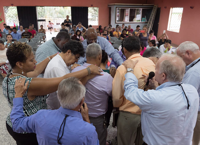 United Methodist bishops from the U.S. pray with pastors at Fuente de Luz United Methodist Church, Danlí, Honduras.