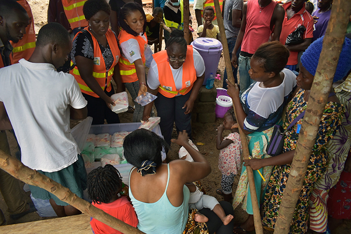 Ethel Sandy (center) leads a group of United Methodist volunteers who handed out food to people affected by the mudslide and floods. Sandy is the Sierra Leone Conference's women's coordinator. Photo by Phileas Jusus, UMNS.
