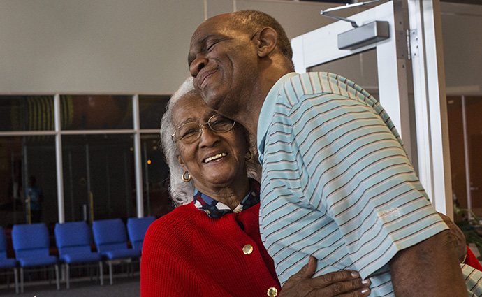 The Rev. Kirbyjon Caldwell greets volunteer Mary Jackson at the doorway of the food and clothing distribution center at Windsor Village United Methodist Church in Houston. Photo by Kathleen Barry, UMNS