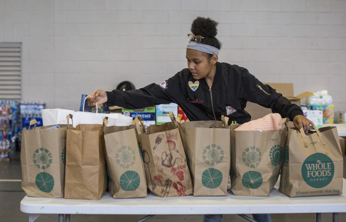 Zamora Contreras, age 13, helps sort items for folks in need following flooding from Hurricane Harvey. She’s a member of Westbury United Methodist Church in Houston, and the church’s gym has become a distribution center for donated items.  Photo by Kathleen Barry, UMNS.