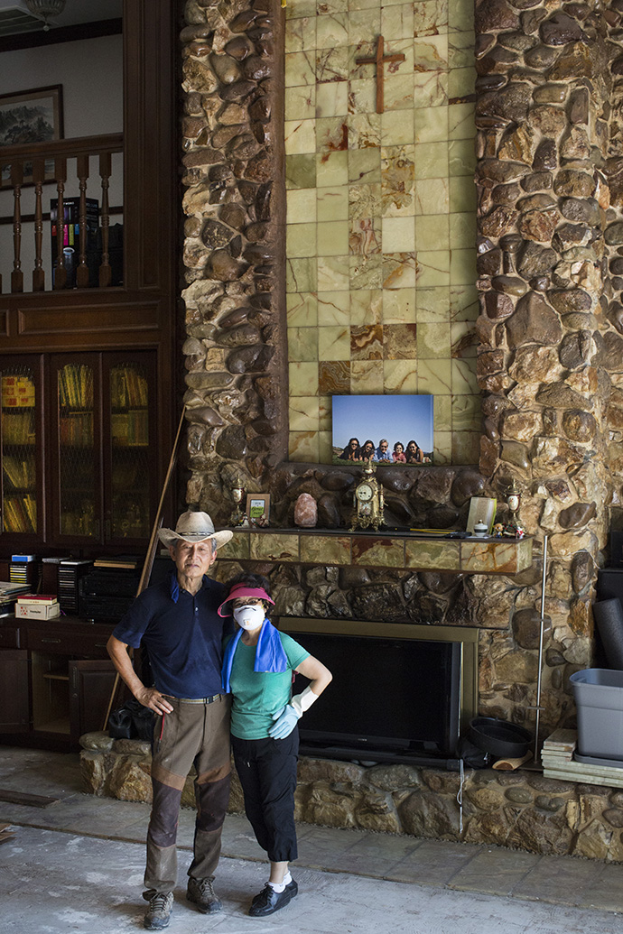 Dan and Grace Cho stand by the fireplace of their Houston home, which flooded following Hurricane Harvey and the release of water from a nearby reservoir. Photo by Kathleen Barry, UMNS.