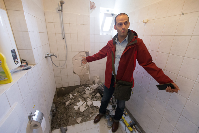 Kuscha Alipoor shows the bathroom he is renovating in his family's apartment at the United Methodist Church of the Redeemer in Bremen, Germany. Alipoor, who took sanctuary at the church, while fighting deportation, is now a member of the church and works as the building superintendent. Photo by Mike DuBose, UMNS.