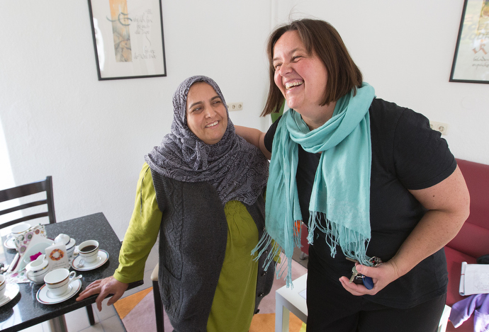 The Rev. Heike Miller (right) introduces Sahize, a recent immigrant from Syria, at Cafe Gegenueber, a weekly gathering for coffee, cake and conversation at the United Methodist Church in Lorsbach, Germany. Photo by Mike DuBose, UMNS.