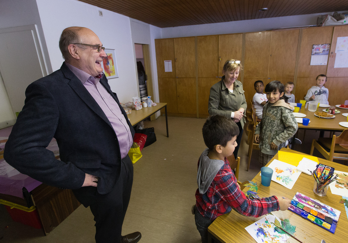 The Rev. Karsten Mohr (left) visits with immigrant children in an educational enrichment program at the United Methodist Peace Church in Hamburg, Germany. Photo by Mike DuBose.