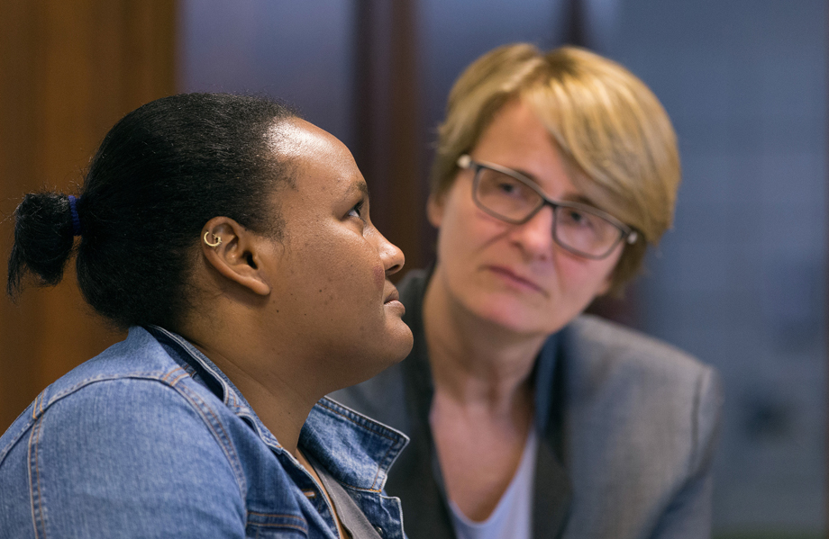 The Rev. Susanne Nießner-Brose (right) listens while a 27-year-old Sudanese woman who asked that she be called Fatima relates her story of fleeing Sudan to seek religious freedom in Europe. She  is taking asylum at the United Methodist Church of the Redeemer in Bremen, Germany, where Nießner-Brose is pastor. Photo by Mike DuBose, UMNS.