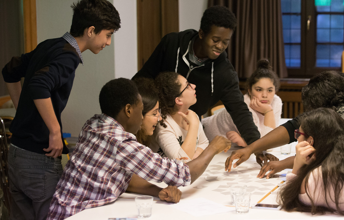 Members of the international youth group YOLO, or You Only Live Once, play a card game at  the United Methodist Church of the Redeemer in Bremen, Germany. The group has youth from Syria, Iran, Ghana and Nigeria. Photo by Mike DuBose, UMNS.