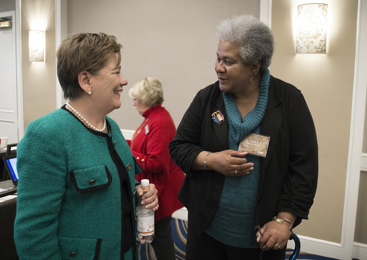 The Rev. Kim Cape (left), top executive of the United Methodist Board of Higher Education and ministry, chats with Althea Spencer-Miller, of Drew University Theological School, during a break at a Nov. 12-15 colloquy in Boston. The event brought together United Methodist scholars and bishops to consider God’s mission for the denomination. 