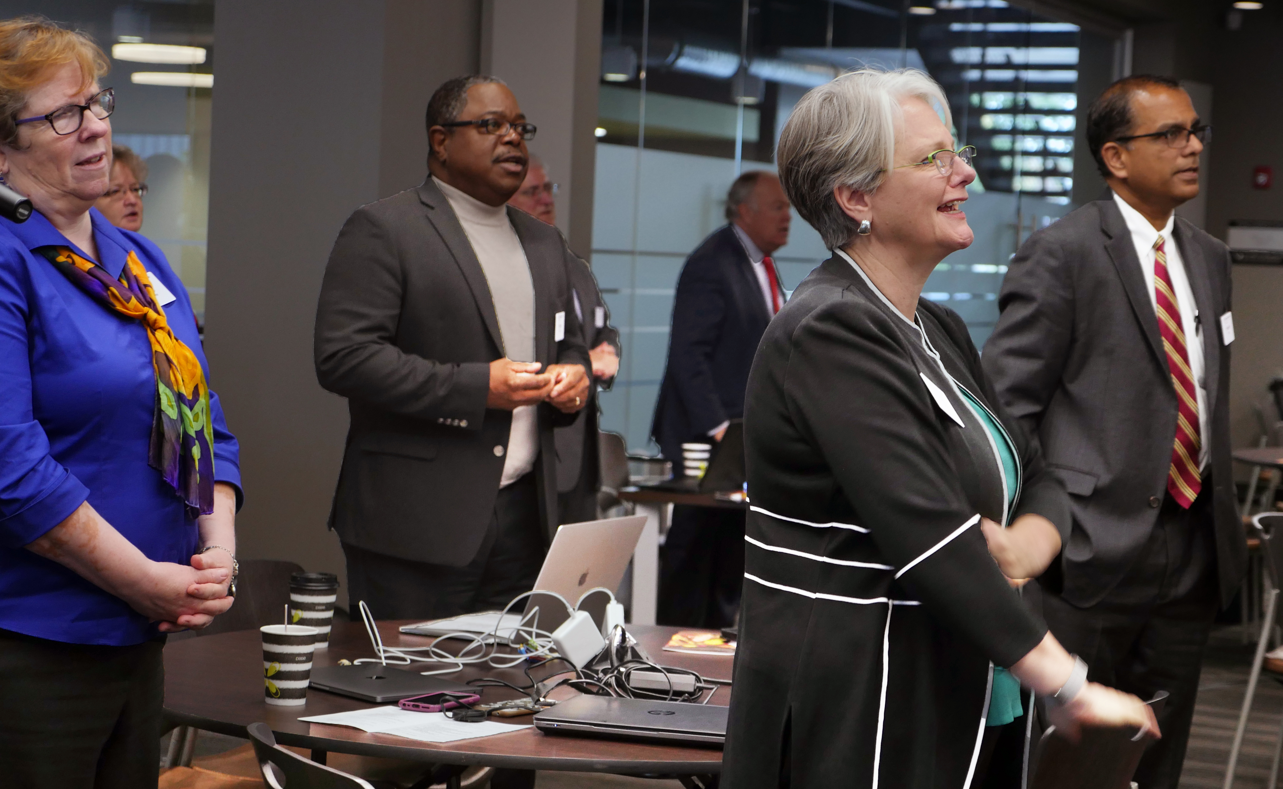The Rev. Sandra Olewine, Reggie Clemons, Kathryn Croskery Jones and Vasanth Victor (from left) join in worship at the General Council on Finance and Administration board meeting in November in Nashville, Tenn. Photo by Heather Hahn, UMNS