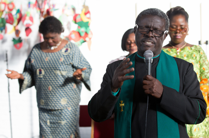 The Rev. Aaron Gaisie-Amoah leads a prayer at Wesley United Methodist Church, a Ghanaian congregation in Hamburg, Germany. Photo by Mike DuBose, UMNS.