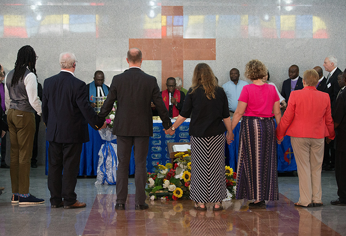 Members of the United Methodist Standing Committee on Central Conference Matters gather for Communion at Canaan United Methodist Church in Abidjan, Côte d'Ivoire. Consecrating the elements is Bishop Benjamin Boni (center). Photo by Mike DuBose, UMNS.