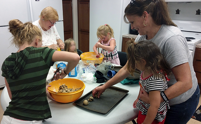Christine Zimmerman, far right, joins with families from First United Methodist Church in Greensburg, Pa., to bake cookies for a nearby homeless shelter. Members of the church’s mission team still speak of how the Zimmermans helped ignite the church’s outreach to the community. Photo courtesy of the Zimmermans.