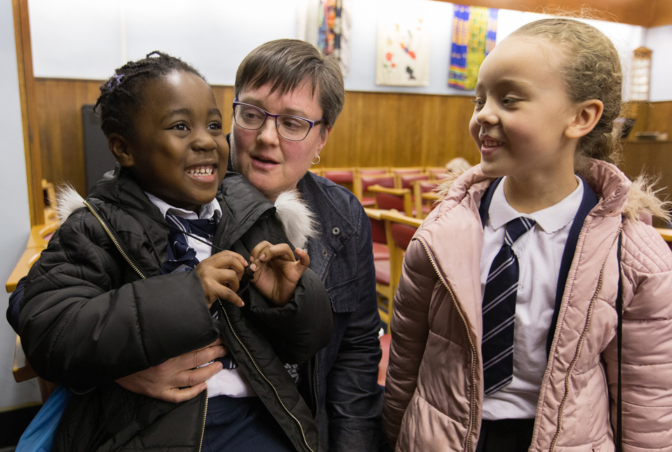 Nwarebea Baffoe (left) and Rebecca Henry, both age 6, stop by after school to visit with the Rev. Janet Corlett at Bermondsey Central Hall Methodist Church in London.