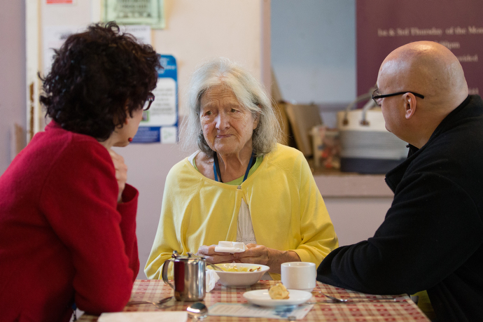 Patricia (center) visits with the Rev. Kathleen LaCamera Loughlin (left) and Andy Hodgkins during the community café. Loughlin is a United Methodist chaplain working in the area and Hodgkins is chair of the community garden and workshop at the center. Photo by Mike DuBose, UMNS.