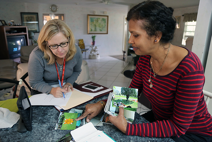 The Rev. Laura Ice (left), recovery coordinator for the Florida Conference, works through claim paperwork with Nirmala Narayan. Narayan’s home in Sebring was the first case opened by the conference’s case managers in Central Florida. Photo by Deborah Coble, Florida Conference.